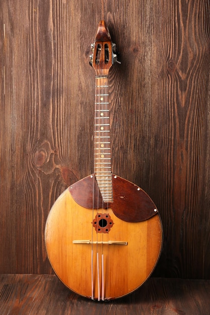 Folk musical instrument domra on wooden background