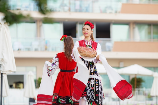 Folklore group dressed in traditional clothing is preforming Bulgarian national dances.