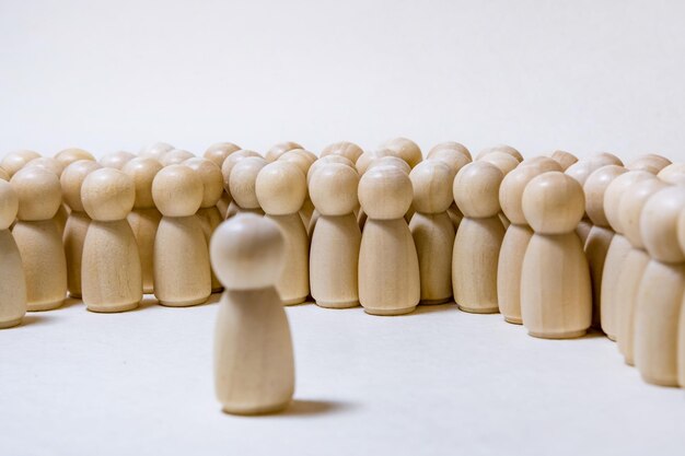 Follow the leader or human resource management concept crowd of wooden people