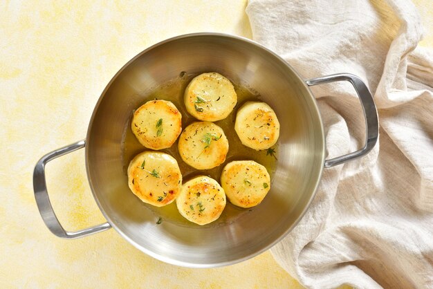 Fondant potatoes in pan