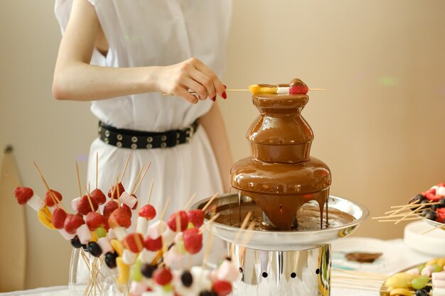 Fondue with a chocolate fountain and sweets for it.Sweet theme.