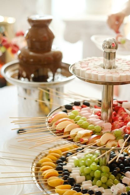 Fondue with a chocolate fountain and sweets for it.Sweet theme.