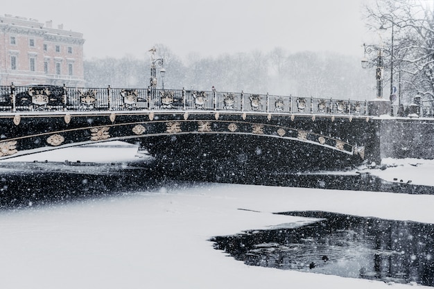 Fontanka river embankment in Saint Petersburg, Russia during snowfall in winter weather