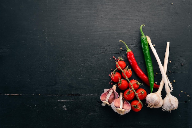 Food Background. Cherry tomatoes, spices and sauces. Top view. On a wooden background. Free space for text.