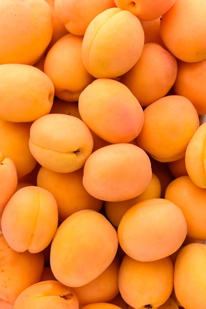 Food background many ripe yellow apricots top view