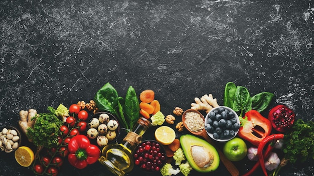 Food background Set of food on an old black background The concept of healthy eating Top view Free space for text