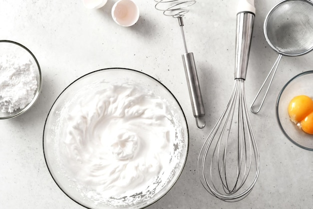 Food background of whipped eggs ingredients and kitchen appliances