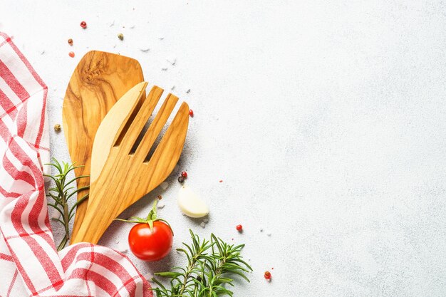 Food background with herbs spices and utensil top view on white background