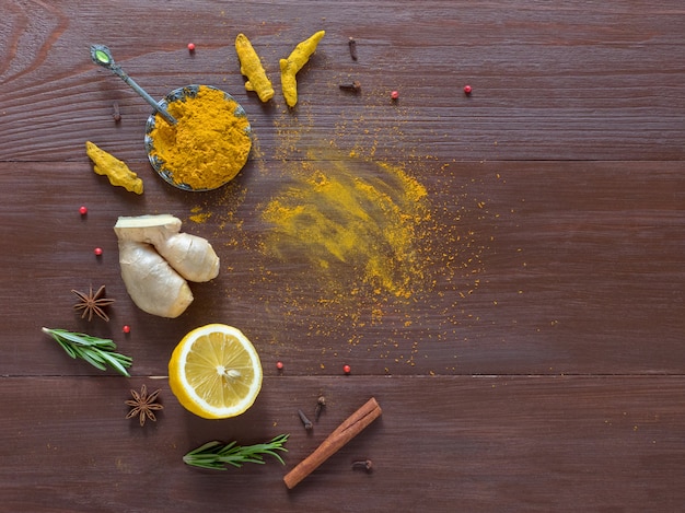 Food background with turmeric, cinnamon,ginger, lemon and pepper