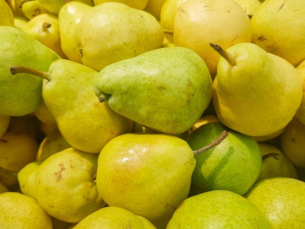 Food background yellow and green fresh ripe pears closeup view from above organic fruit concept