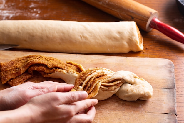 Food bakery concept making bread dought for Cinnamon Roll Braided Bread with copy space