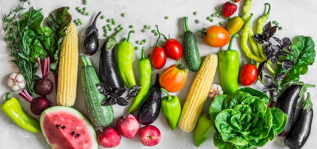 Food banner Garden organic vegetables berries fruits on a light background top view Healthy diet vegetarian food concept Flat lay