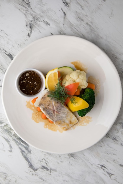 Food banner of meat cut into strips lemon and meal on a white plate