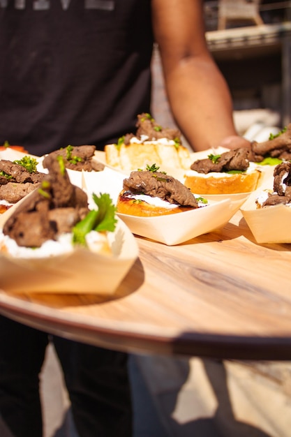 FOOD BEING SERVED BY WAITER AT EVENT