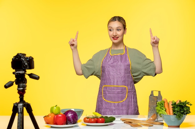 Food blogger cute healthy chef recording video for social media pointing up