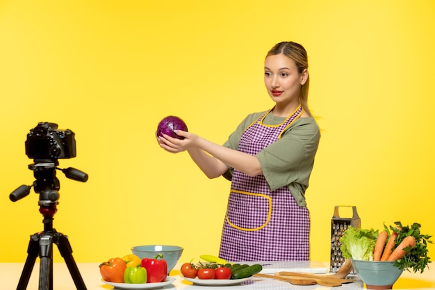 Food blogger pretty cute healthy chef recording video for social media holding onion