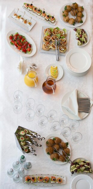 Food for a buffet on the table top view Snacks A festive table with dishes and drinks