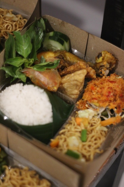 food catering fried chicken box rice with vegetables and fresh vegetables