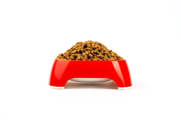 Food for cats and dogs in a red bowl on a white background