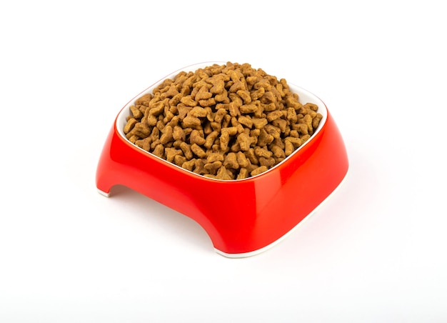 Food for cats and dogs in a red bowl on a white background