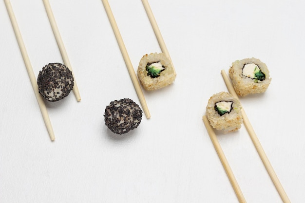 Food composition Chopsticks sushi with black and white sesame seeds