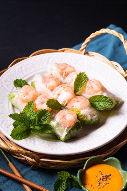 Food concept asian food homemade prawn vietnamese rice paper spring roll and peanut dipping sauce with copy space