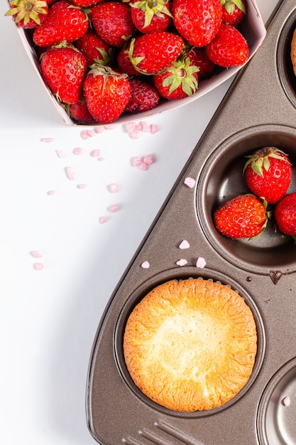 Food concept Fresh homemade Baking cupcake and Wild strawberrys in cupacake pan