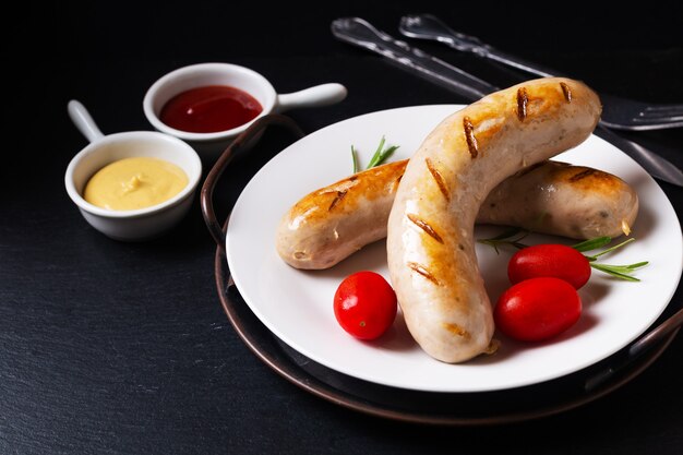 Food concept Grilled BBQ White sausages on black background with copy space