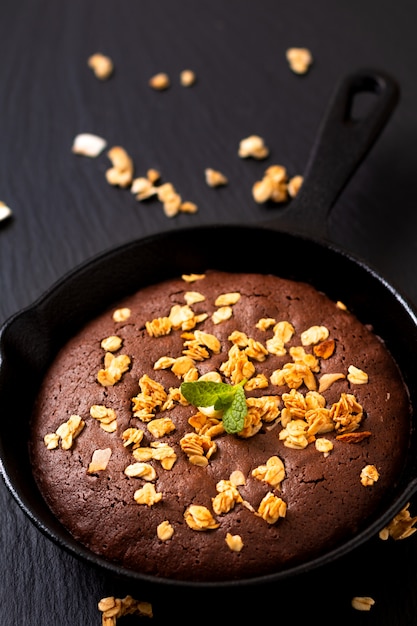 Food concept Homemade Brownies baked in iron cast skillet with copy space