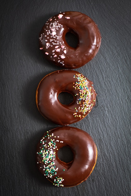 Photo food concept homemade donuts chocolate and colorful sparkling sugar topping
