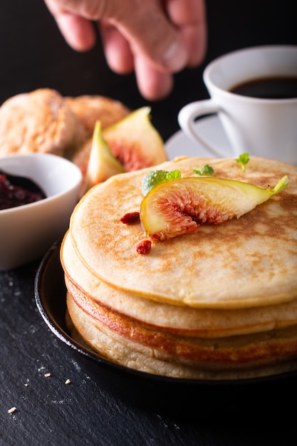 Food concept Homemade organic pancakes stack with fig breakfast on black