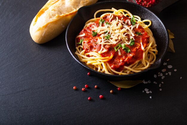 Food concept Homemade spaghetti bolognese in iron cast 