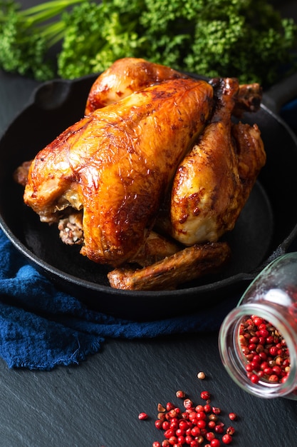 Food concept Roasted, Grilled Whole organic chicken in skillet iron pan