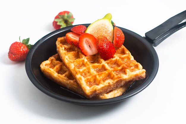 Food concept square Waffles and syrup with strawberry and fig with copy space