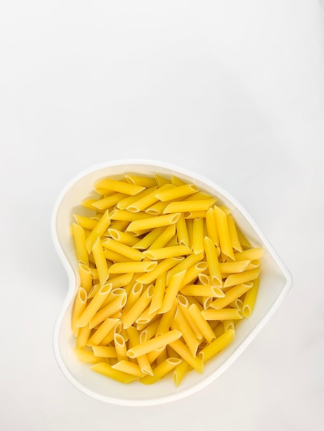 Food concept top view Dry pasta in a white plate closeup