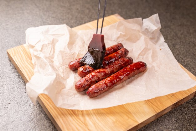 Food concept - Traditional horse meat sausage covered with sauce.