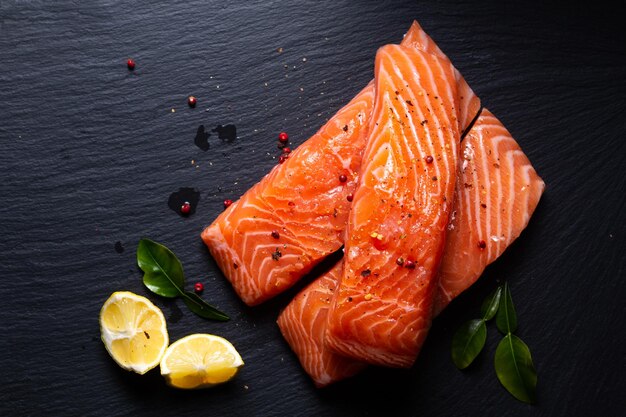 Food concept Uncook fresh salmon on black slate stone board with copy space