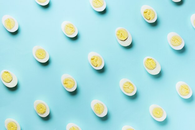 Food concept with boiled eggs pattern on blue background