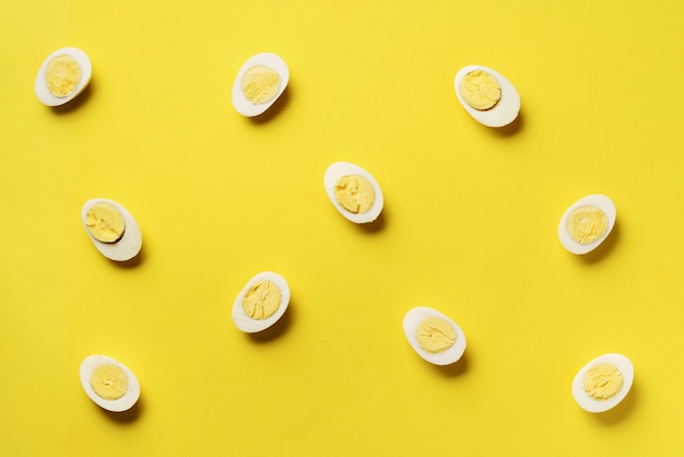 Food concept with boiled eggs pattern on yellow background