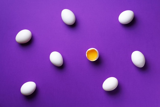 Food concept with white chicken eggs on violet background top view creative pattern in minimal style flat lay