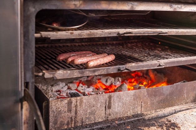 Food, delicious and meat dishes concept - Horse sausages prepared on barbeque.