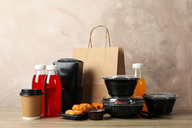 Food delivery. Food in takeaway boxes on wooden table