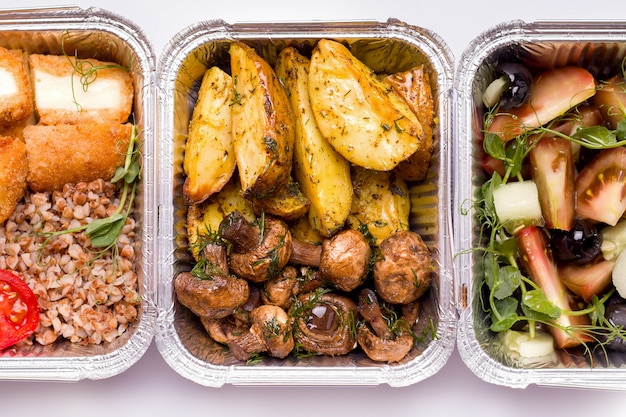 Food delivery. Fried potatoes with mushrooms closeup