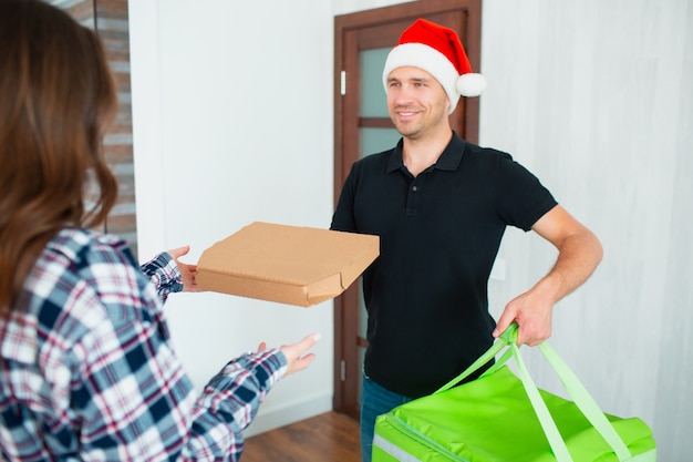 Food delivery man in Santa hat