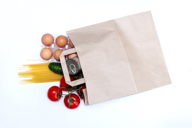 Food delivery Paper bag with fresh products, pasta, canned food, vegetables, butter, eggs. donations