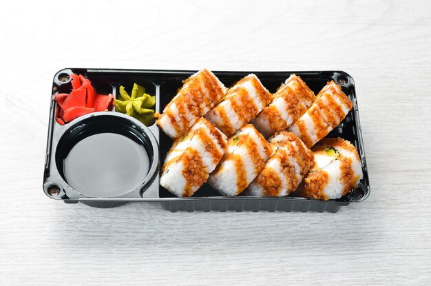 Food delivery Sushi with tuna wasabi and soy sauce in a plastic box Top view