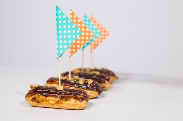 Food, desserts and bakery concept - Eclairs with chocolate decorated as a ship