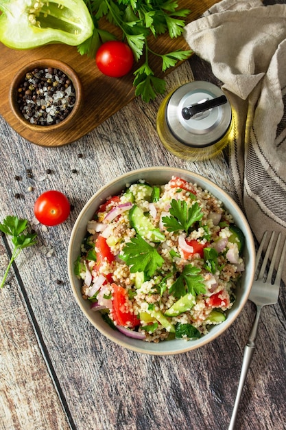 Food dieting concept tuna salad Couscous salad with conserved tuna tomatoes cucumbers Copy space