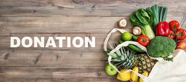 Food donation in a bag on wooden background