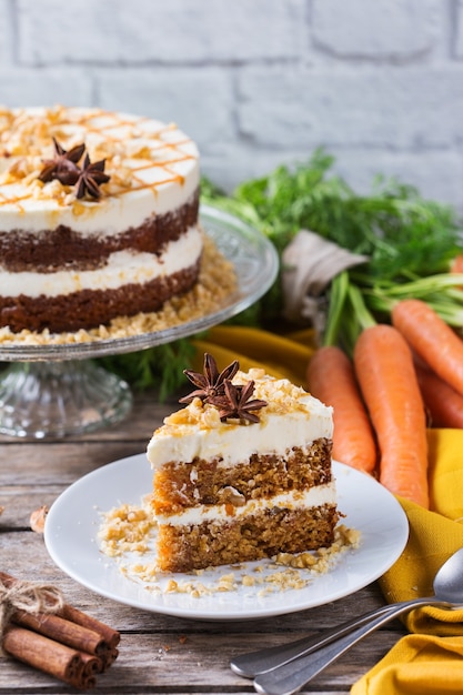 Food and drink concept. Healthy homemade carrot cake with walnuts, nuts and spices on a rustic kitchen table. Easter dessert
